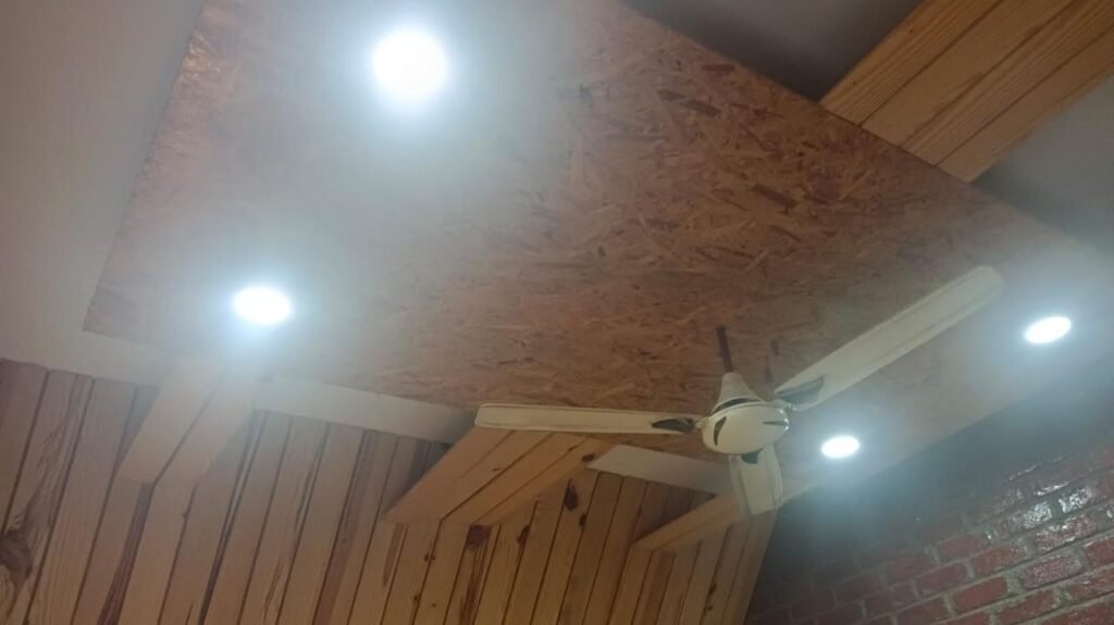Warm wooden ceiling with ambient lighting in a cozy cottage room.
